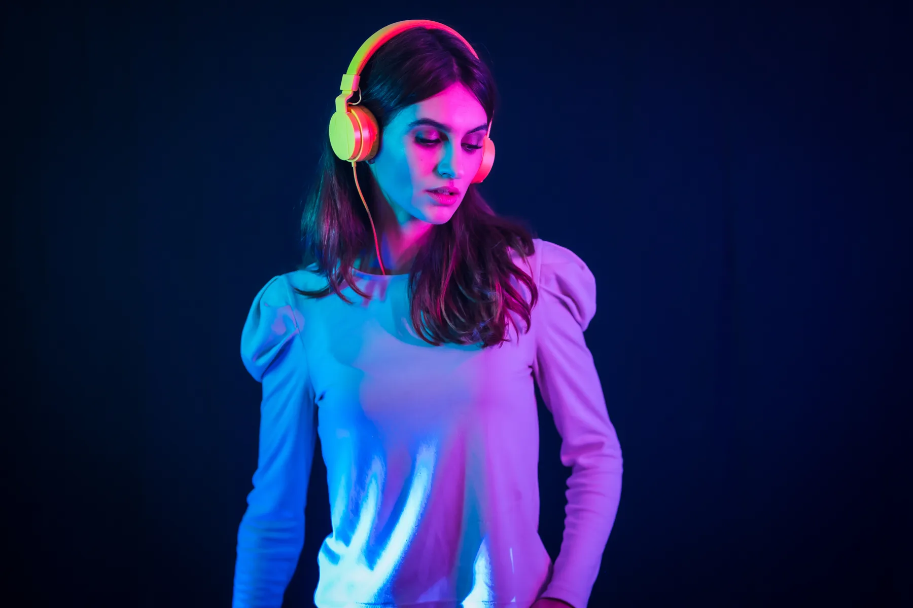 Woman with Headphones in Neon Lighting