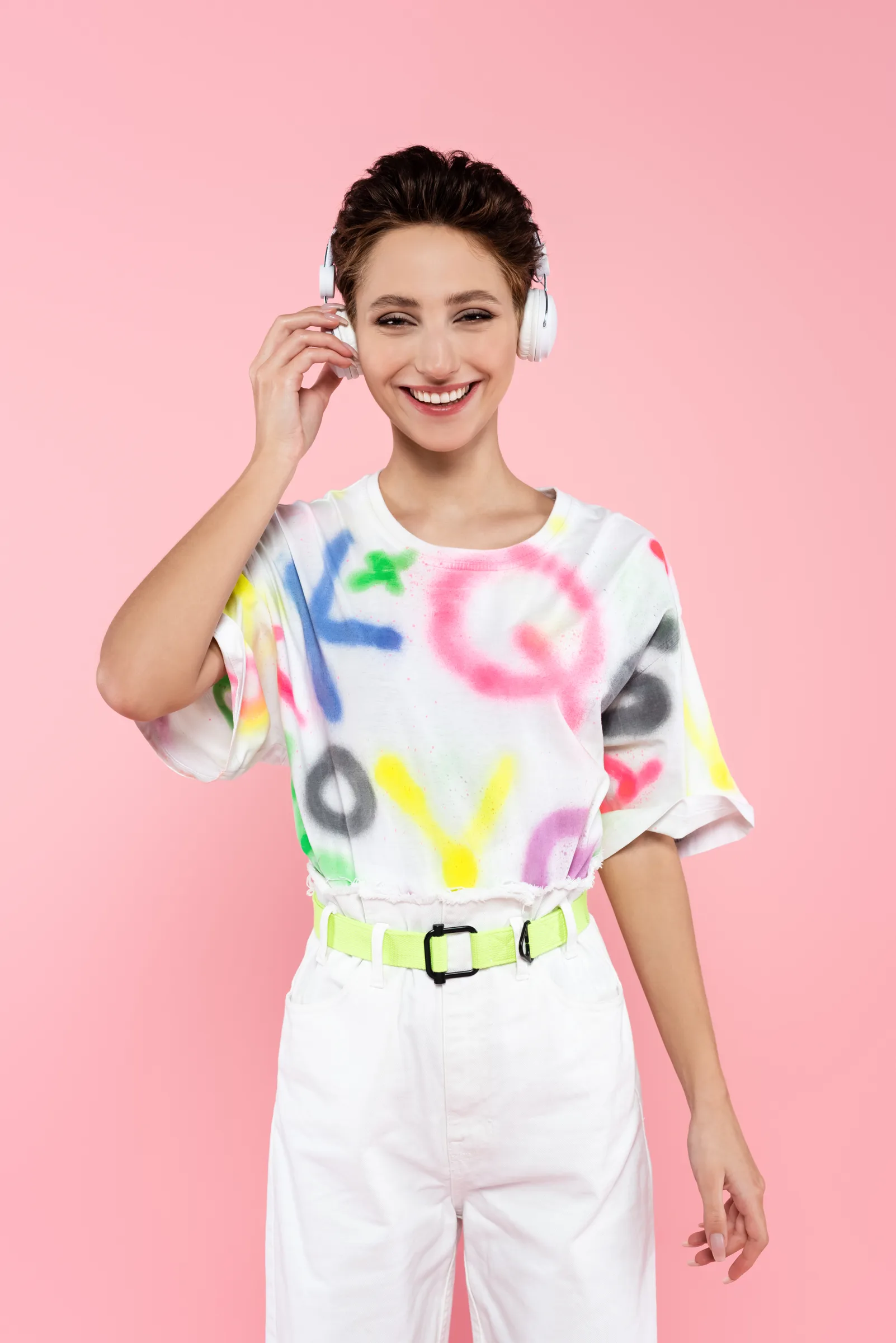 Woman in Colorful Shirt and White Pants Smiling