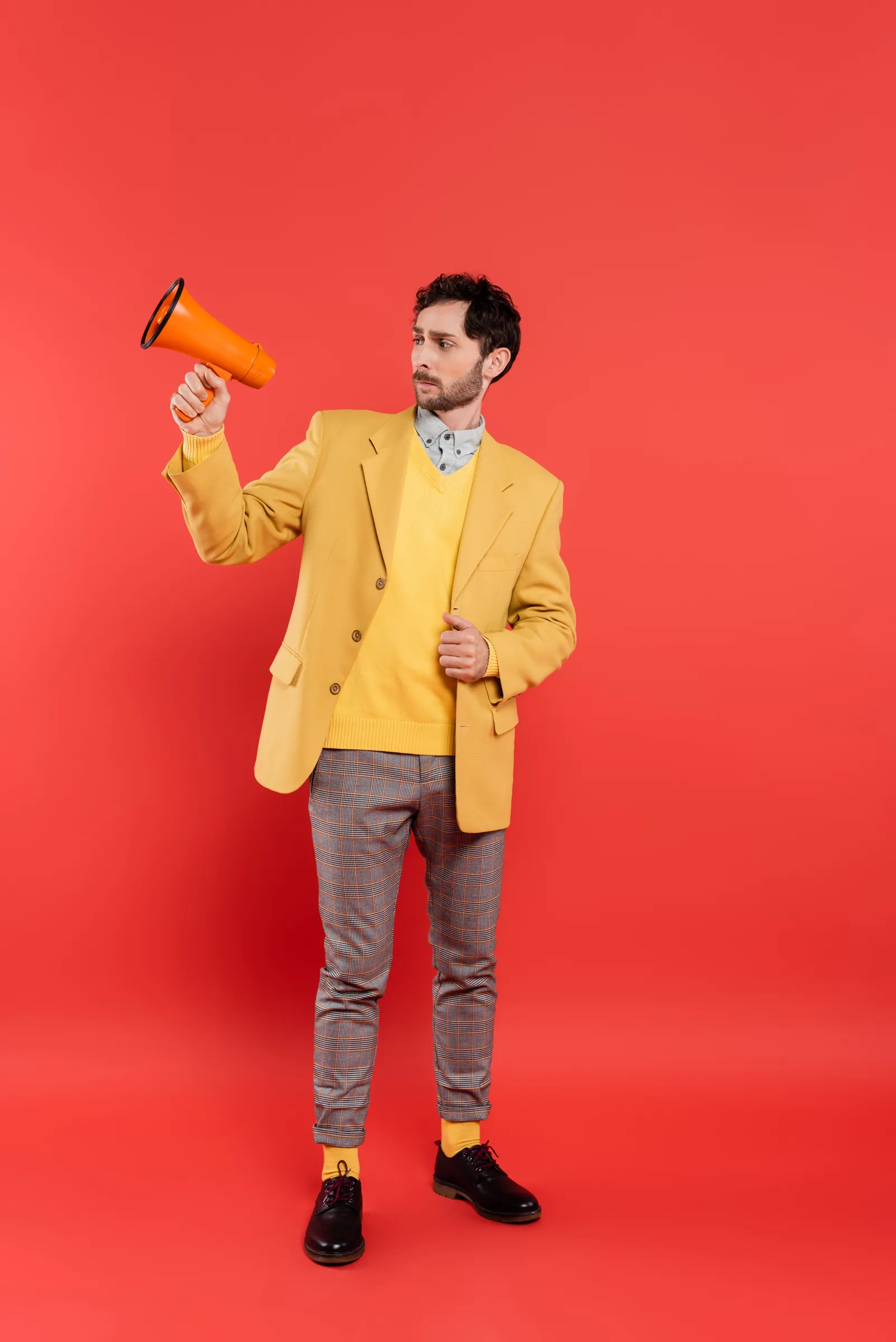 Man With Megaphone Against Red Background