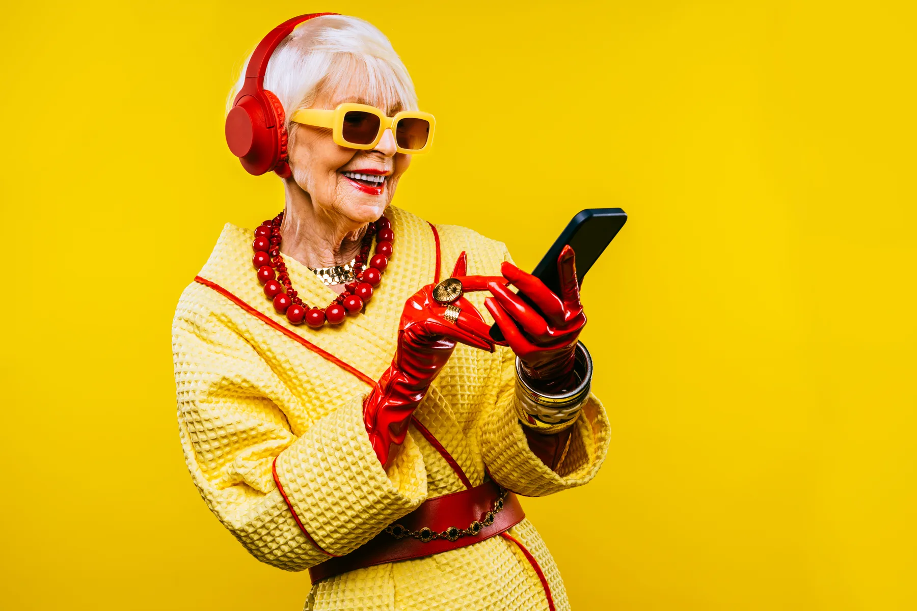 Stylish Senior Woman Enjoys Music On Mobile Phone