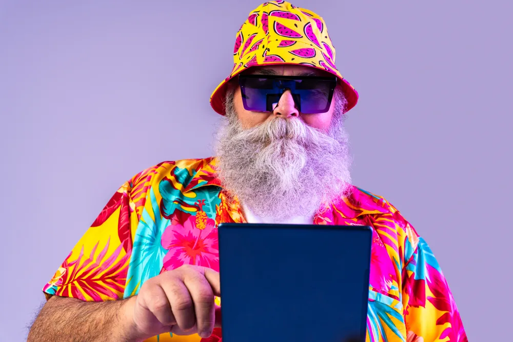 Man with Tablet Wearing Colorful Outfit and Hat
