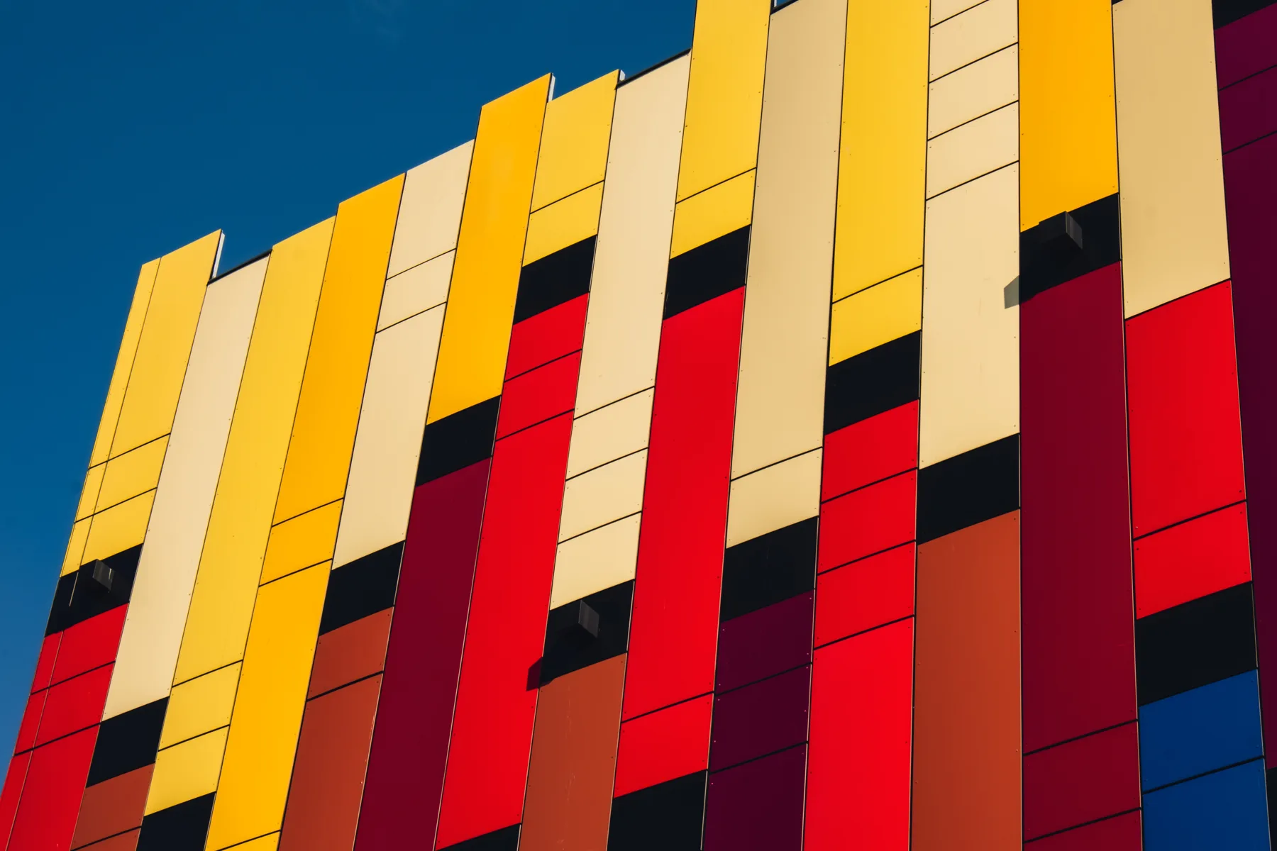Colorful Modern Building Facade under Clear Blue Sky Colorful Modern Building Facade under Clear Blue Sky