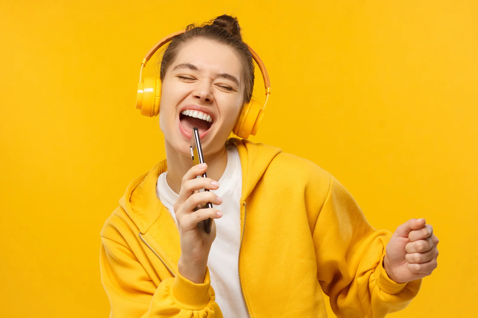Woman singing with headphones