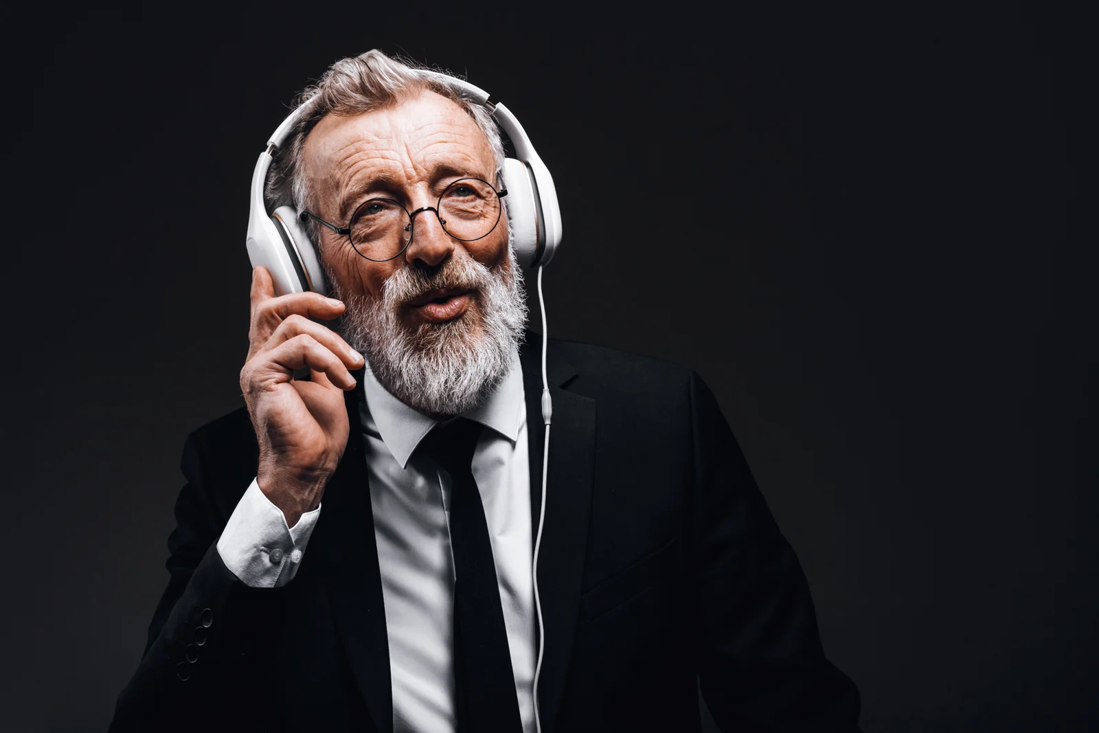 Older man enjoying music through headphones