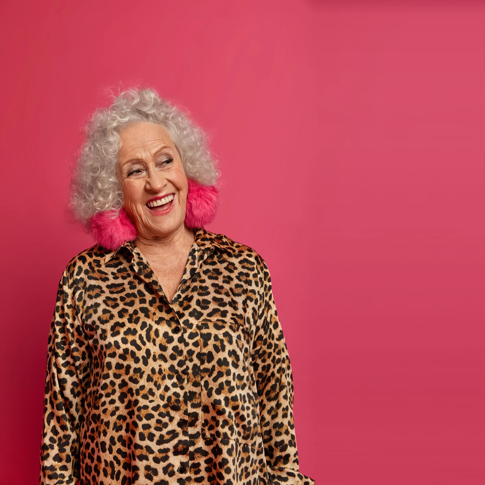 Smiling older woman in a leopard-print shirt