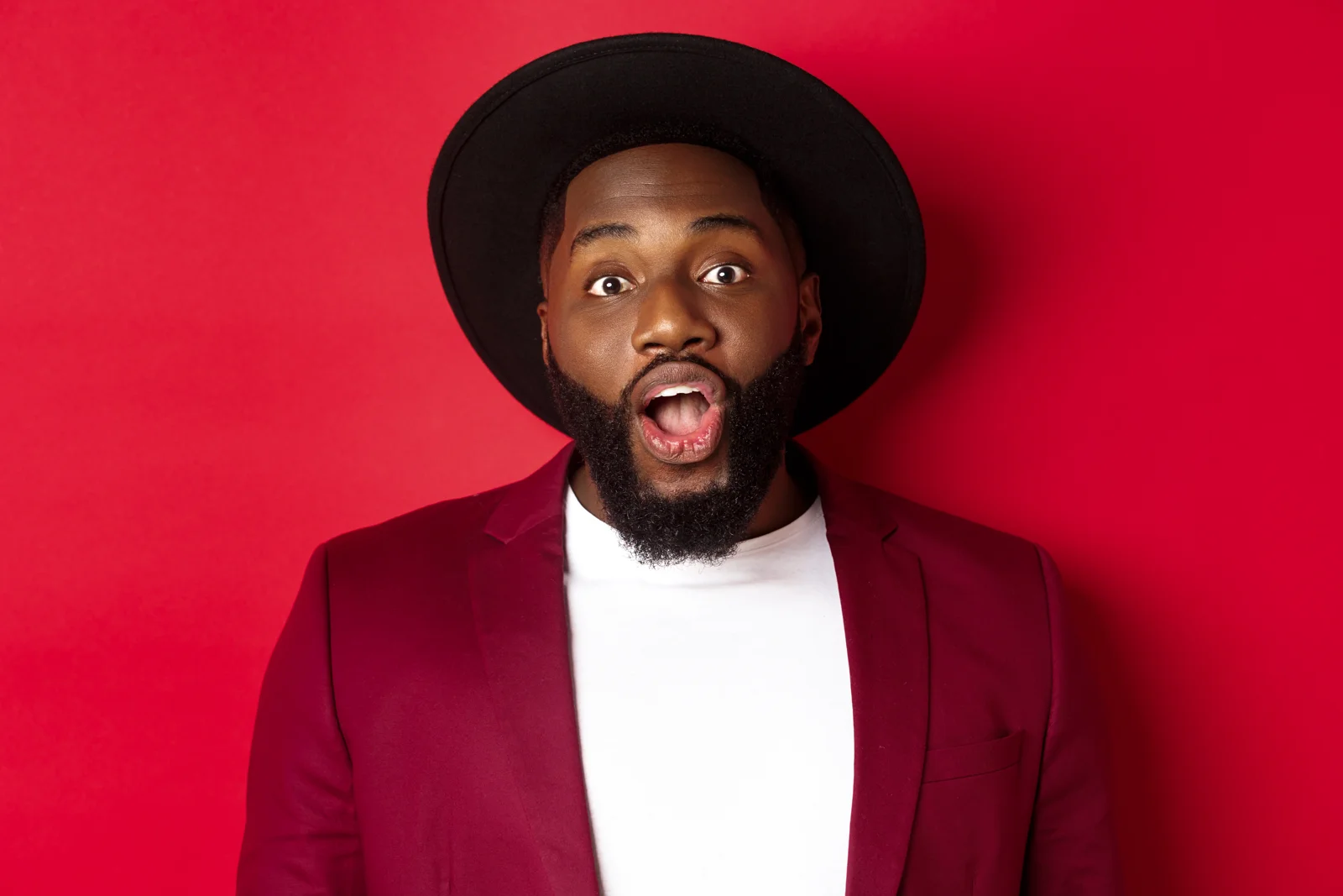 Expressive man in a red blazer and hat