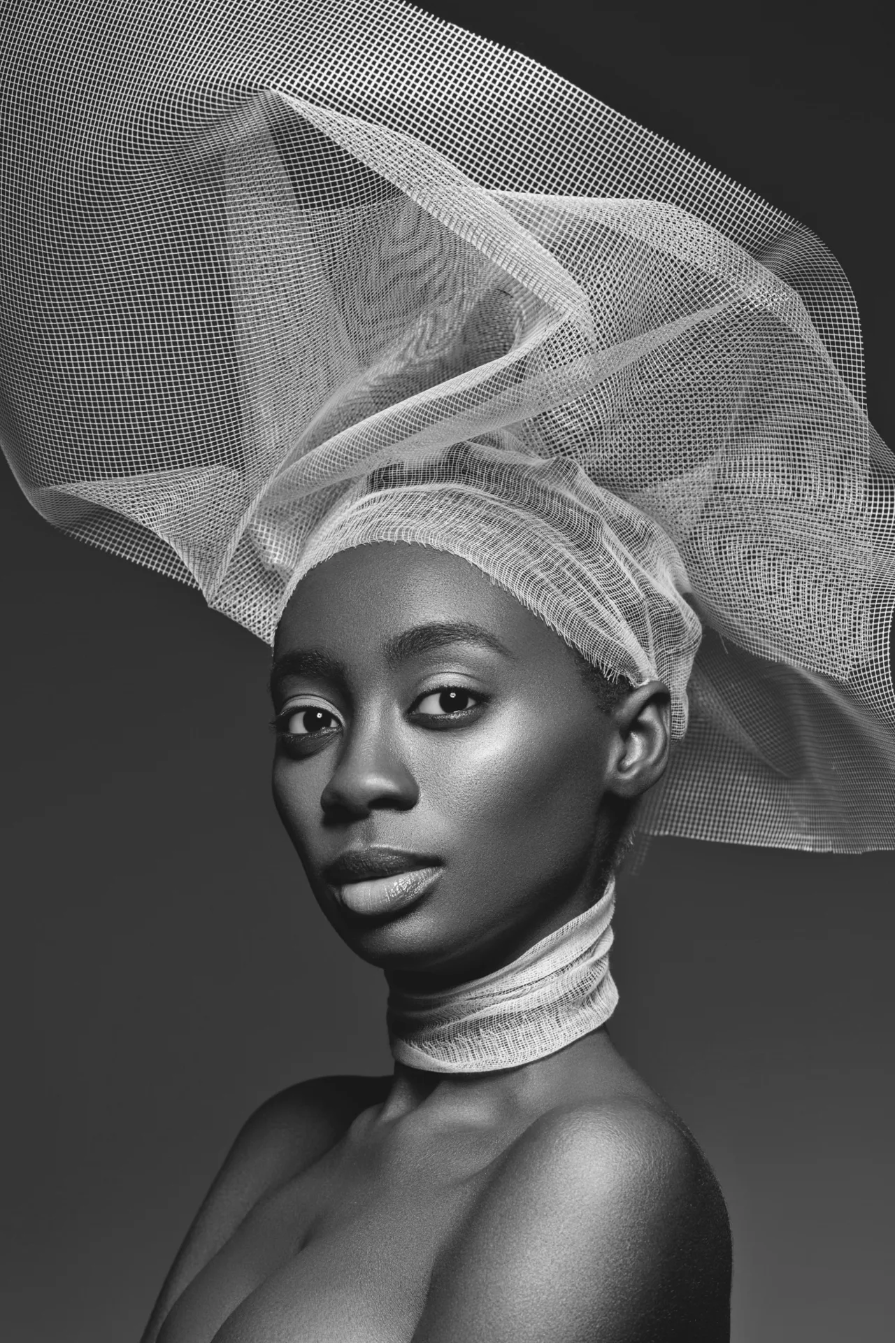 Woman with a sculptural sheer headpiece